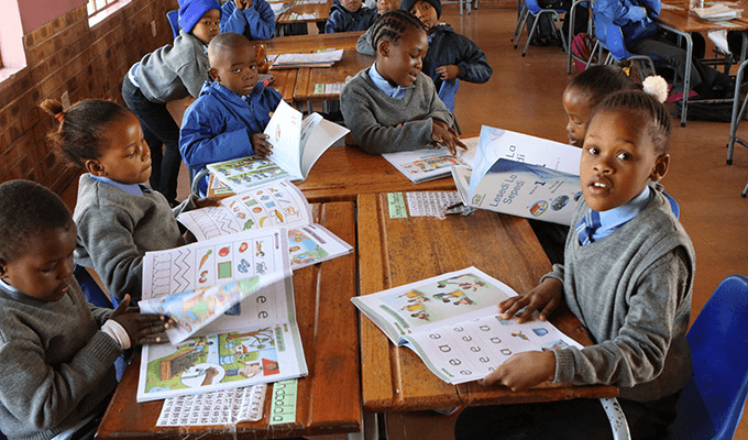 Foundation-phase learner working with literacy and language materials in class.