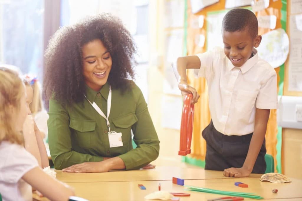 Natural sciences exploration: educator and learner with magnets during a lesson.